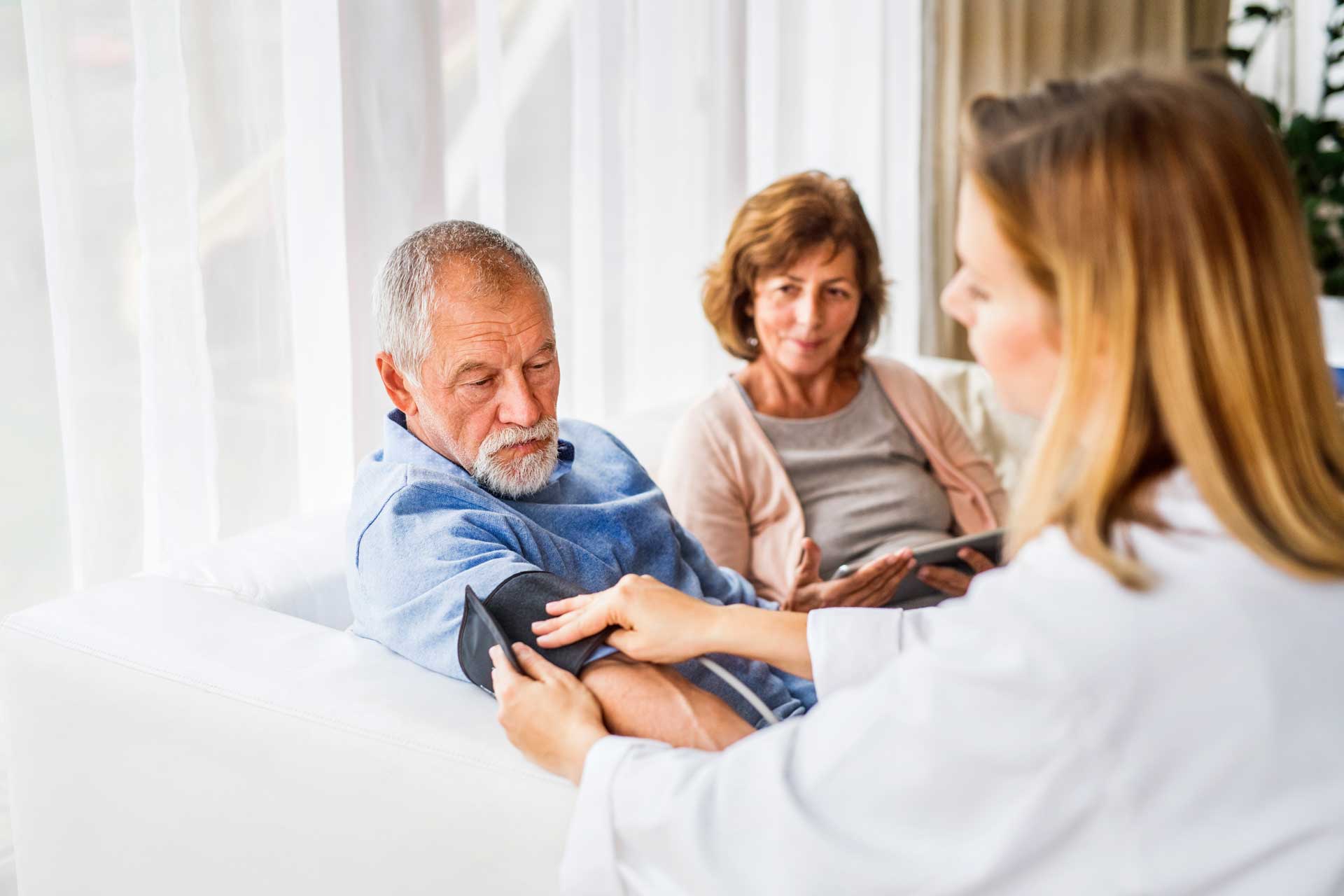female-doctor-checking-blood-pressure-of-senior-ma-PDN3YZZ.jpg